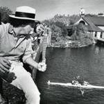 Oct. 22, 1978: Malcolm Logan cheered boats on from the Larz Anderson Bridge. The Weld Boathouse can be seen to the right. This boathouse is home to Harvard’s rowing, boating, and crew teams.